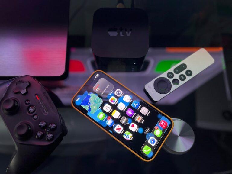 Stylish home entertainment setup featuring an Apple TV device, iPhone, and a gaming controller on a console table