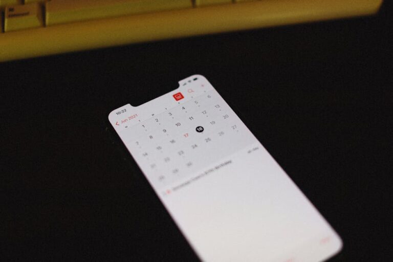 Smartphone showing an illuminated calendar app on a dark background — set a reminder for the next season drop and cancel until then